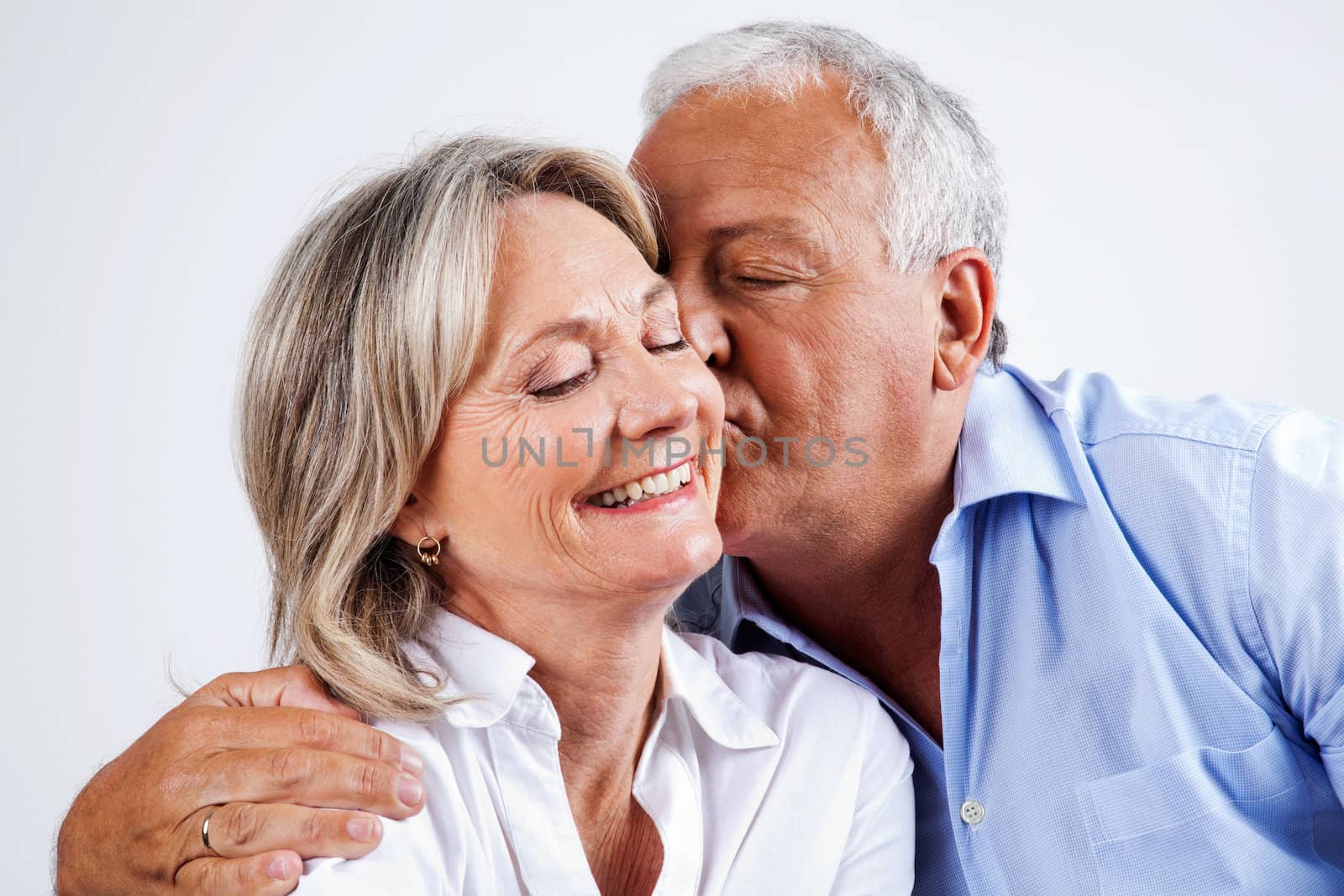 Husband Kissing Wife on Cheek by leaf