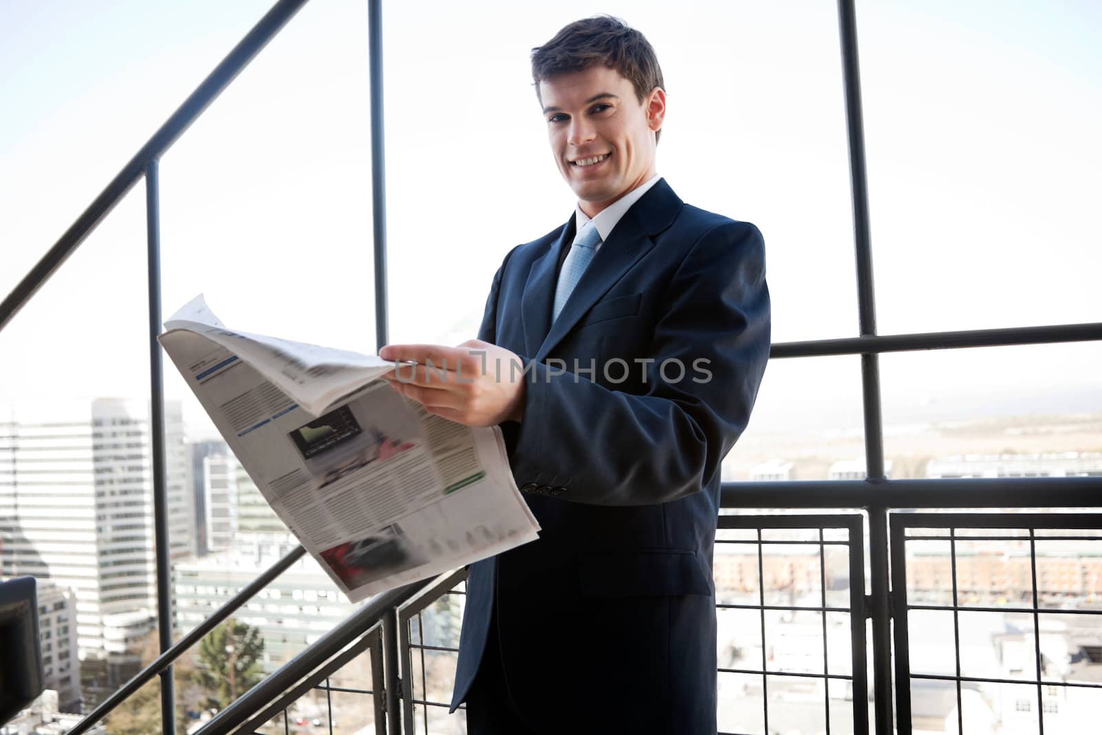 Businessman Holding Newspaper by leaf