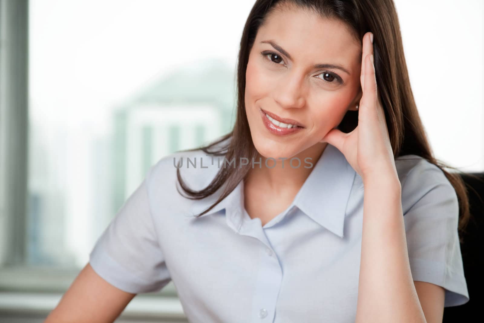 Portrait Of Young Smiling Business Woman With Hand On Head.