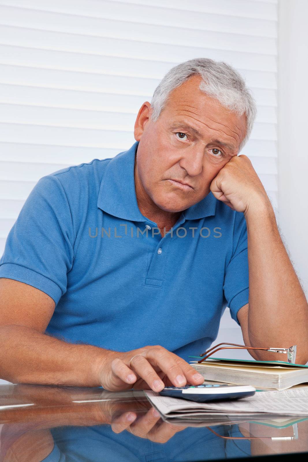 Portrait of senior man upset with financial budget