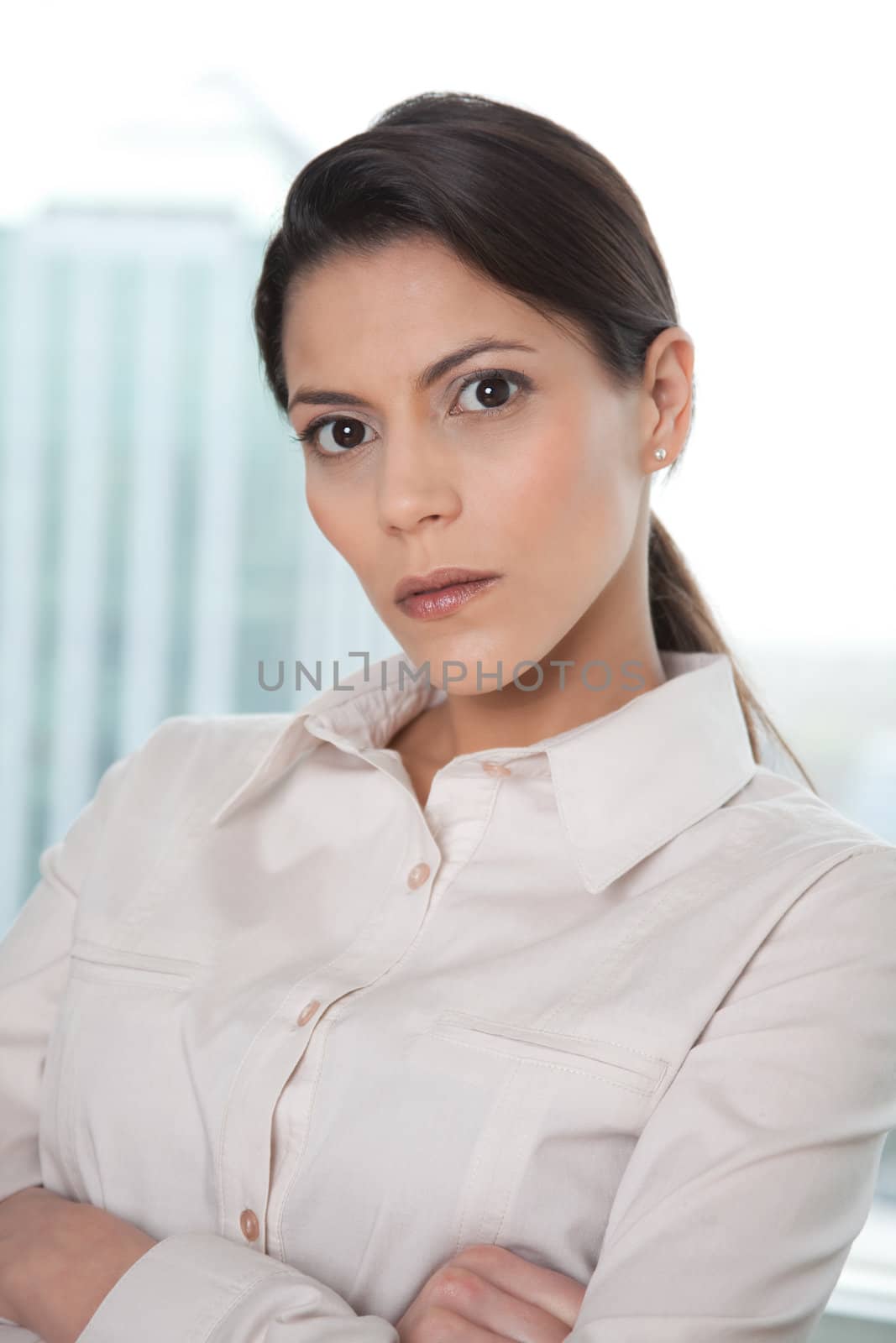 Portrait Of Young Business Woman With Arms Crossed .