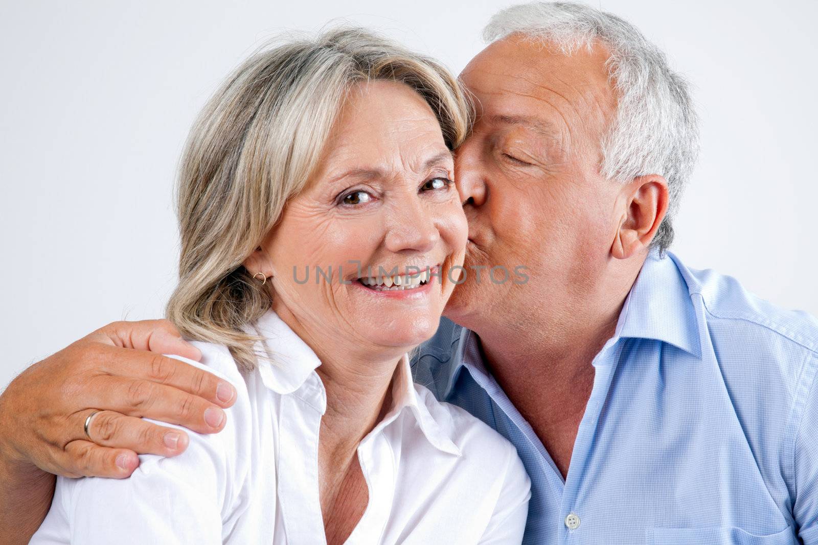 Woman Being Affectionately Kissed By Her Husband by leaf