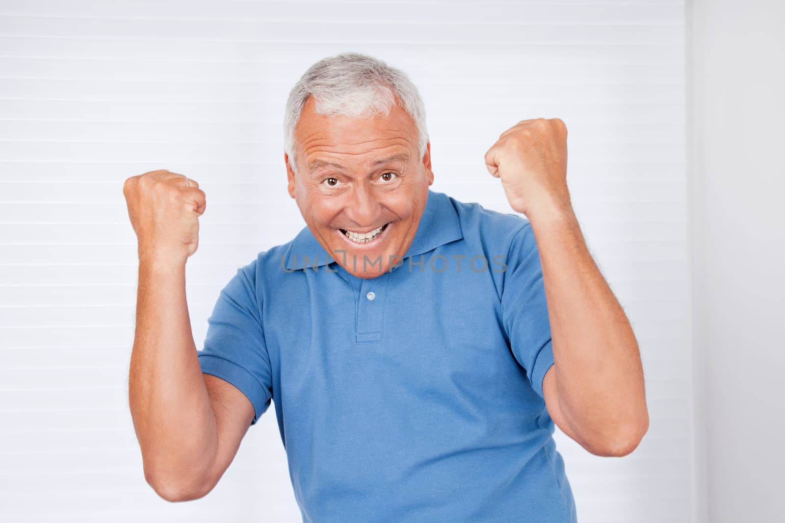 Cheerful Senior Man by leaf