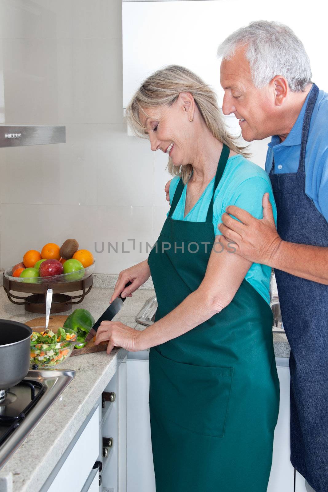 Couple Cooking Food in Kitchen by leaf