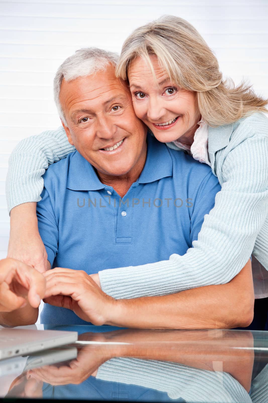 Portrait of happy senior couple embracing