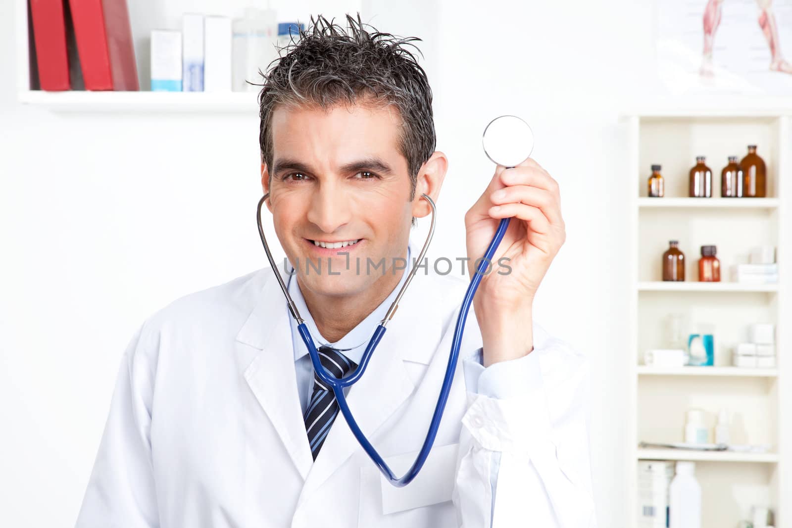 Portrait of male doctor holding stethoscope .