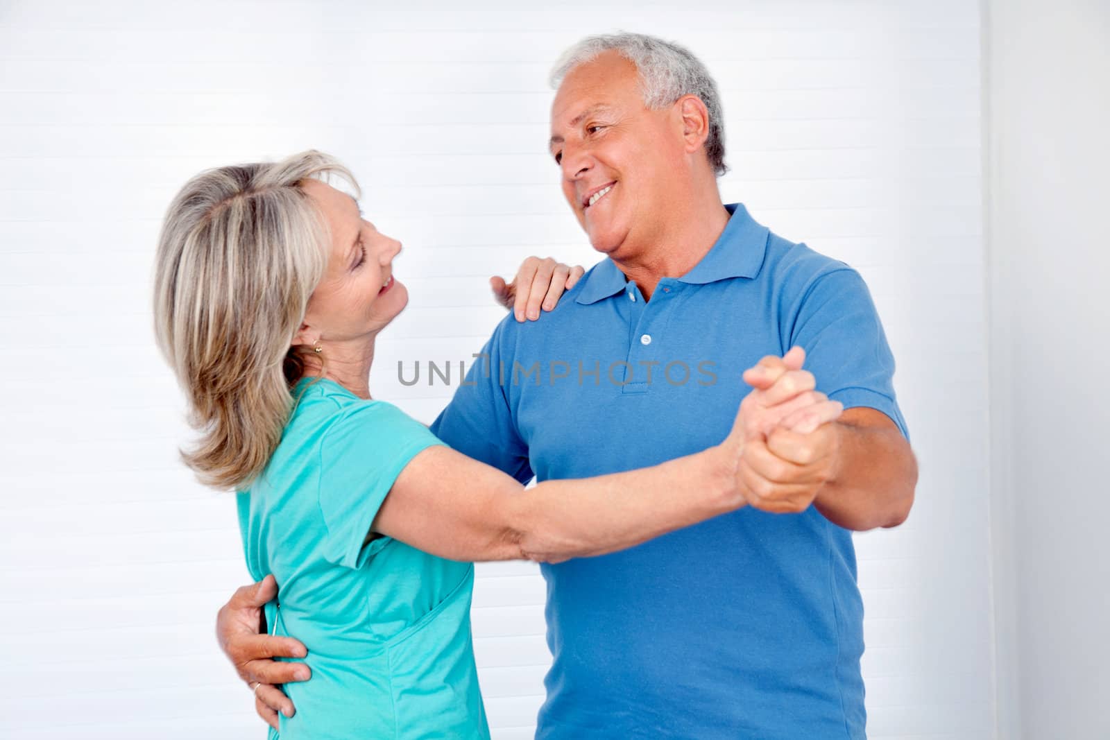 Happy couple enjoying dance together at home