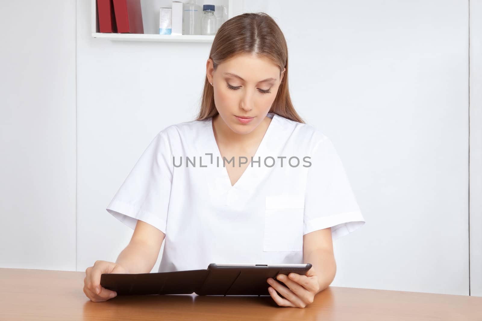 Medical professional using digital tablet.
