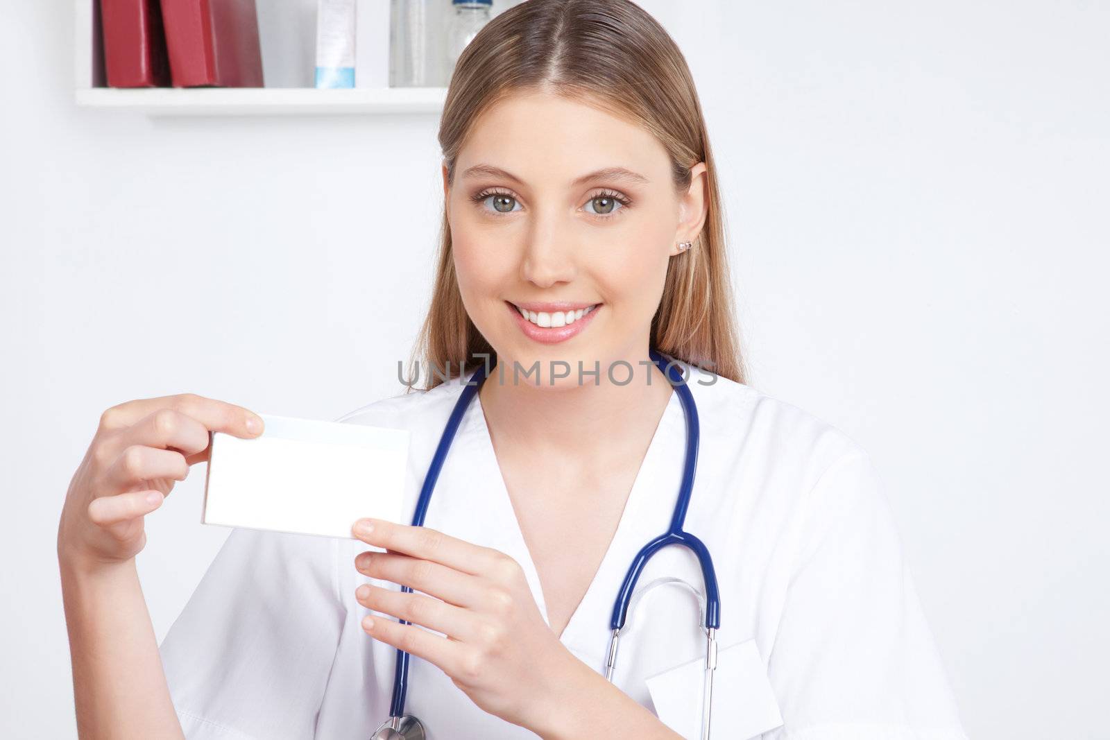 Happy smiling female doctor  holding a medicine packet.