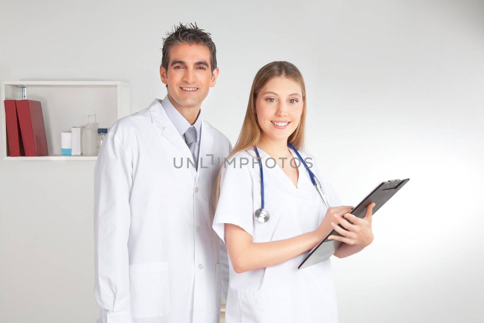 Portrait of happy smiling female and male doctor .