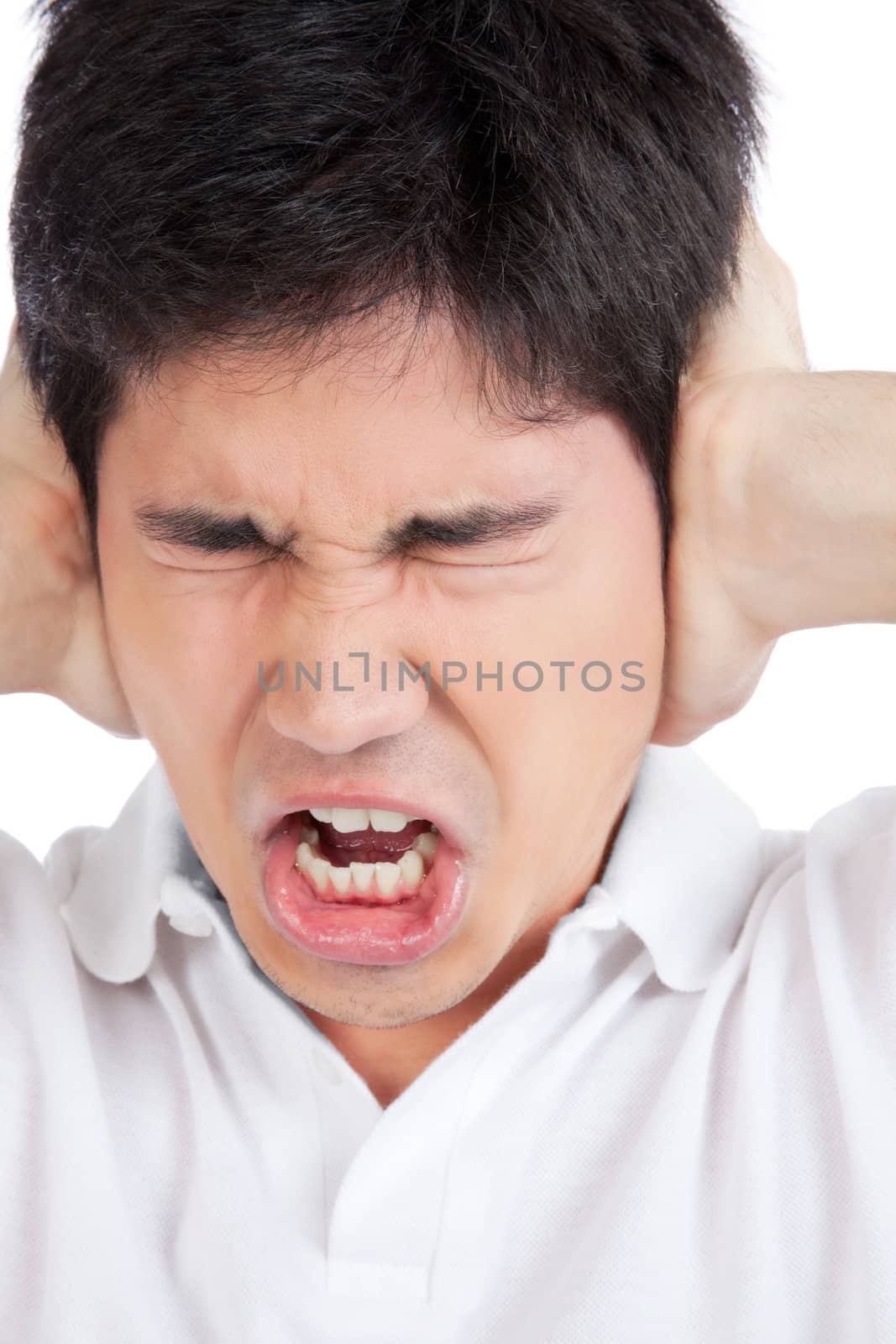 Young asian man yelling and covering ears .