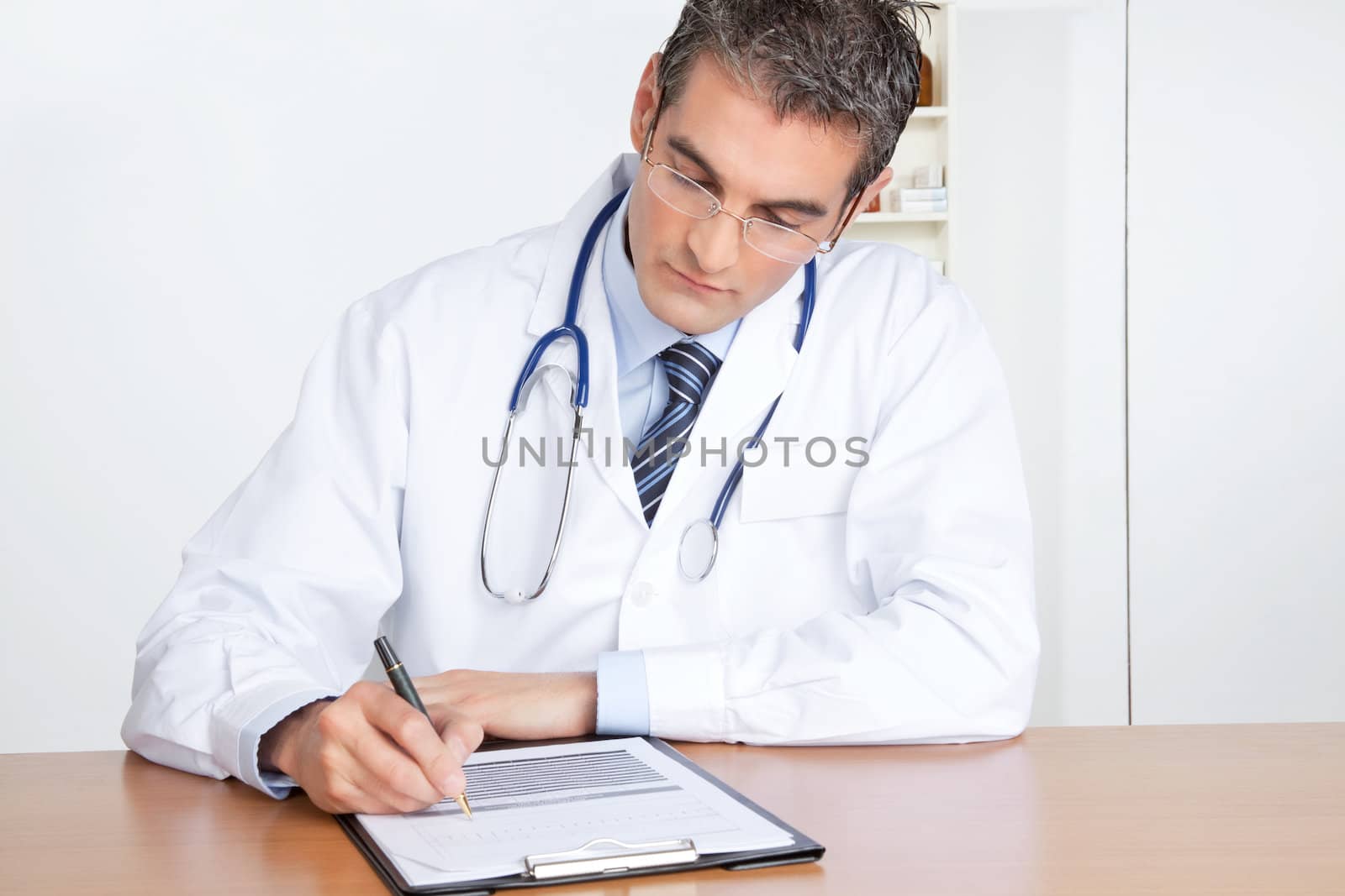 Male Doctor Writing on Clipboard by leaf