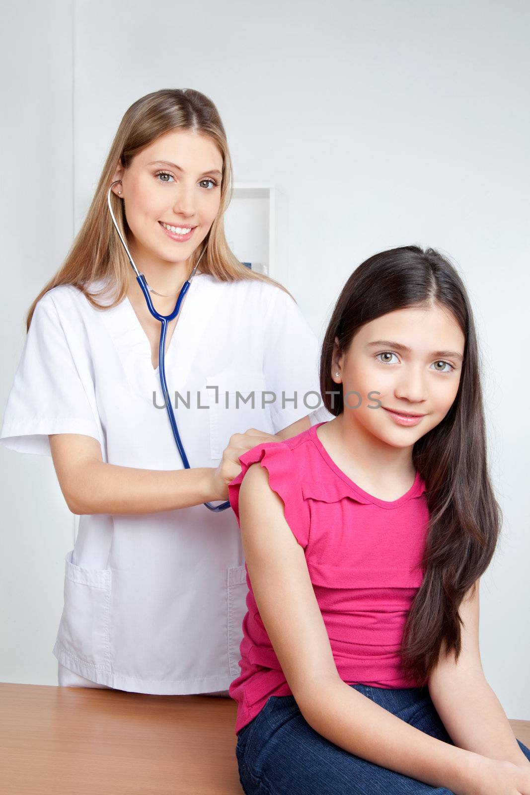 Doctor Examining Child in Clinic by leaf