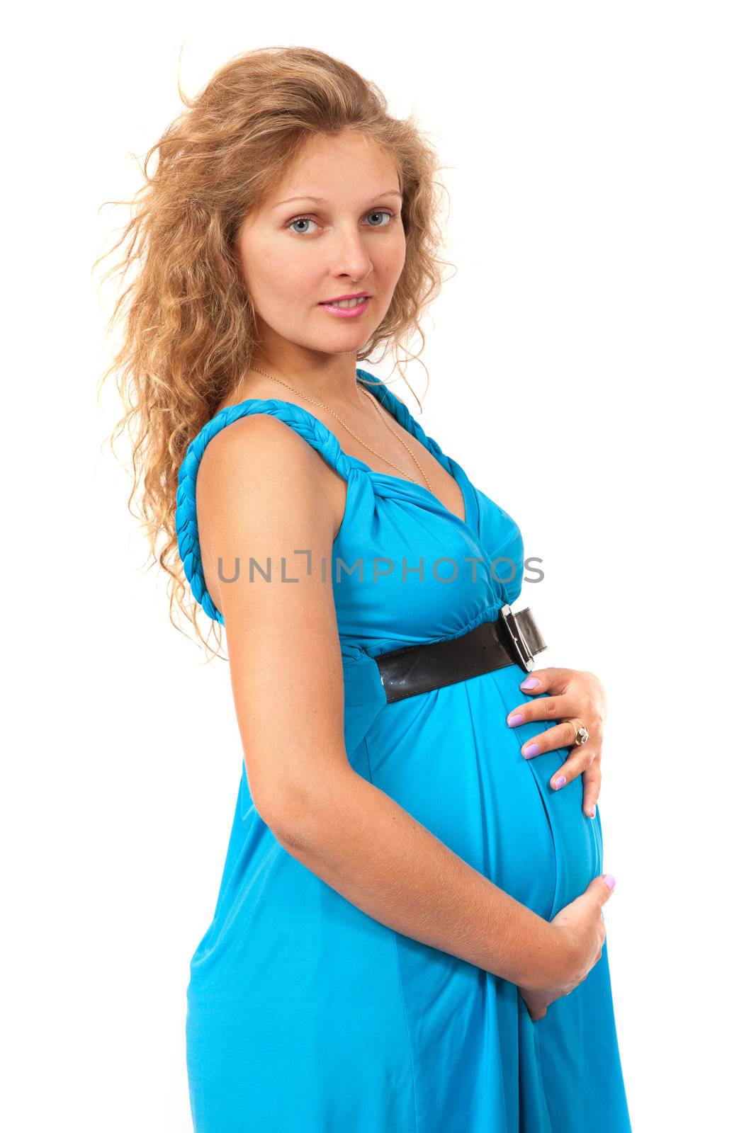 Pregnant woman is caressing her belly over white background