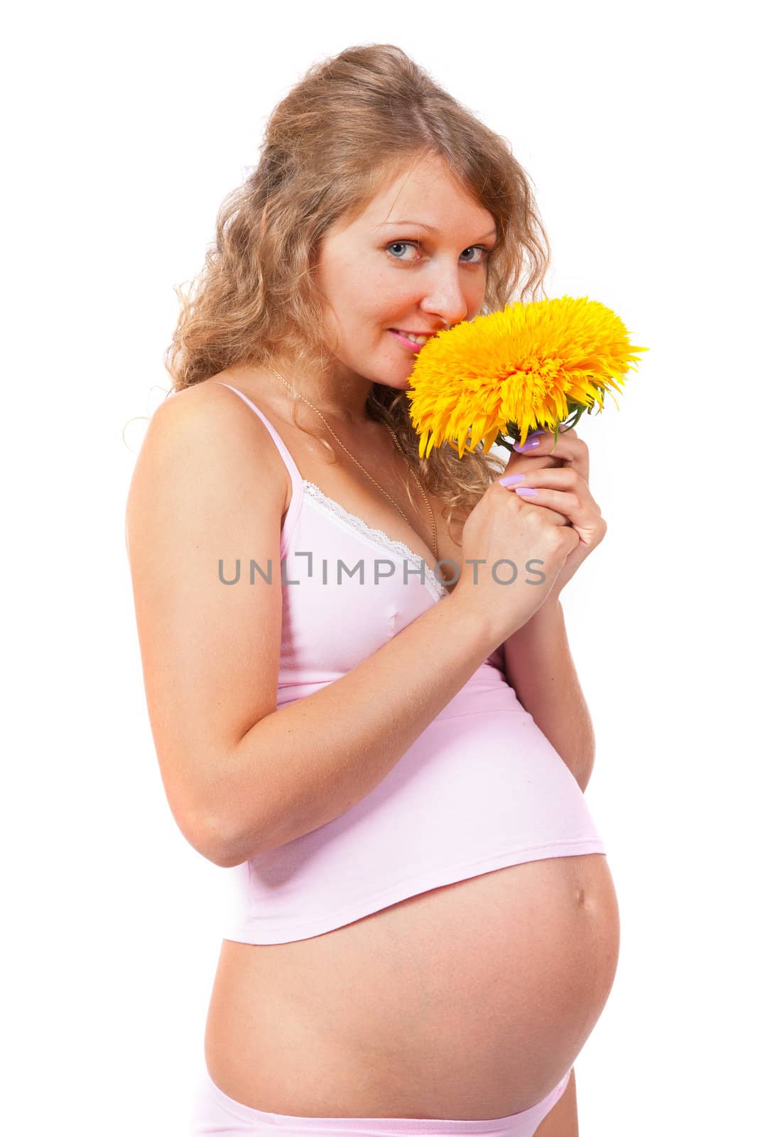 Pregnant woman is caressing her belly over white background