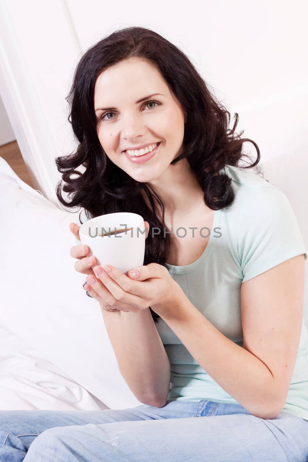 smiling brunette woman drinking black coffee in the morning