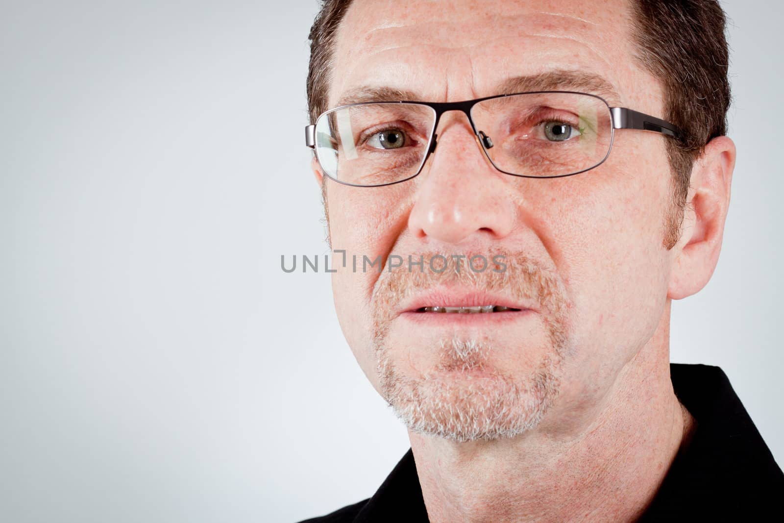 attractive adult man with glasses and black shirt portrait 