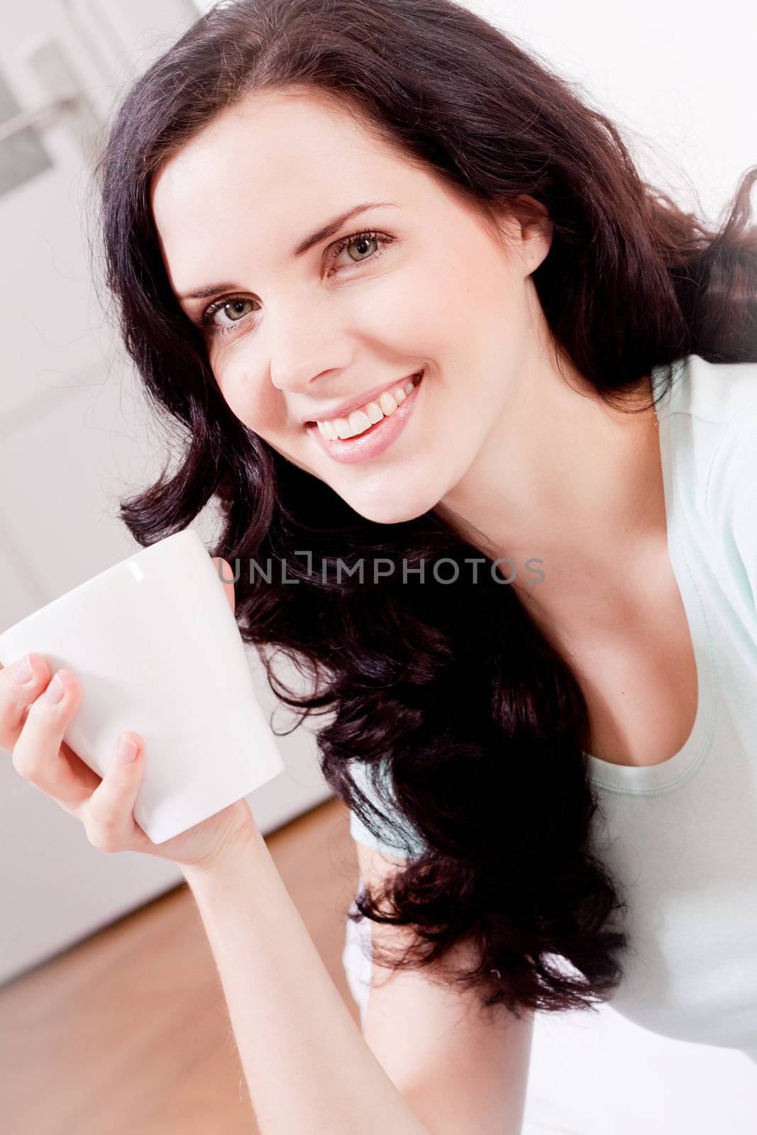 young attractive woman is drinking hot coffee in the morning