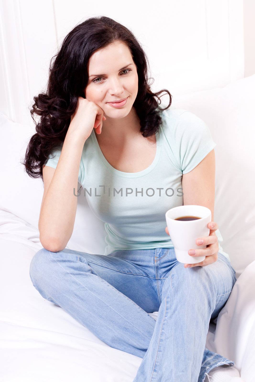 young attractive woman is drinking hot coffee in the morning