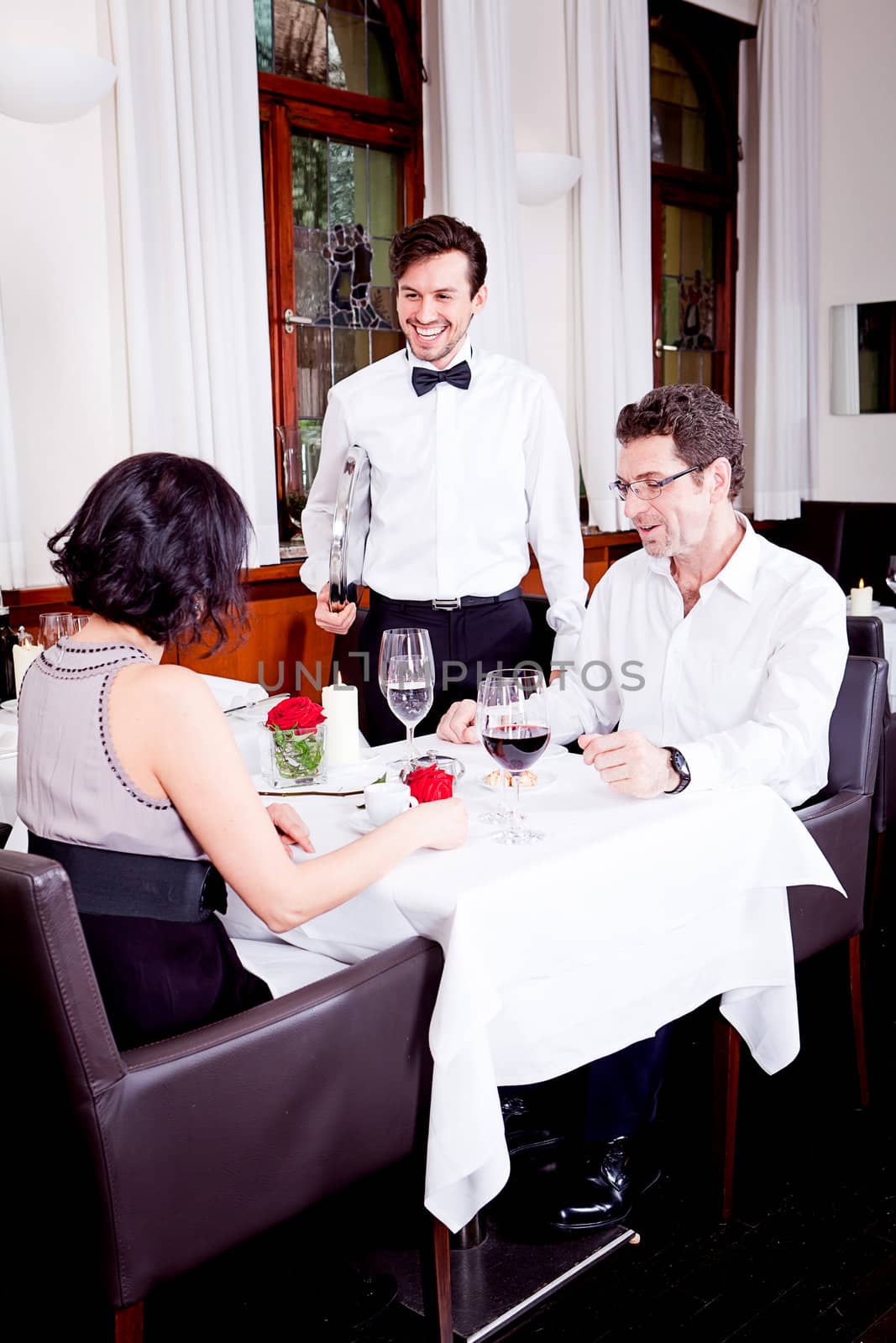 waiter serve fresh espresso for happy couple  by juniart