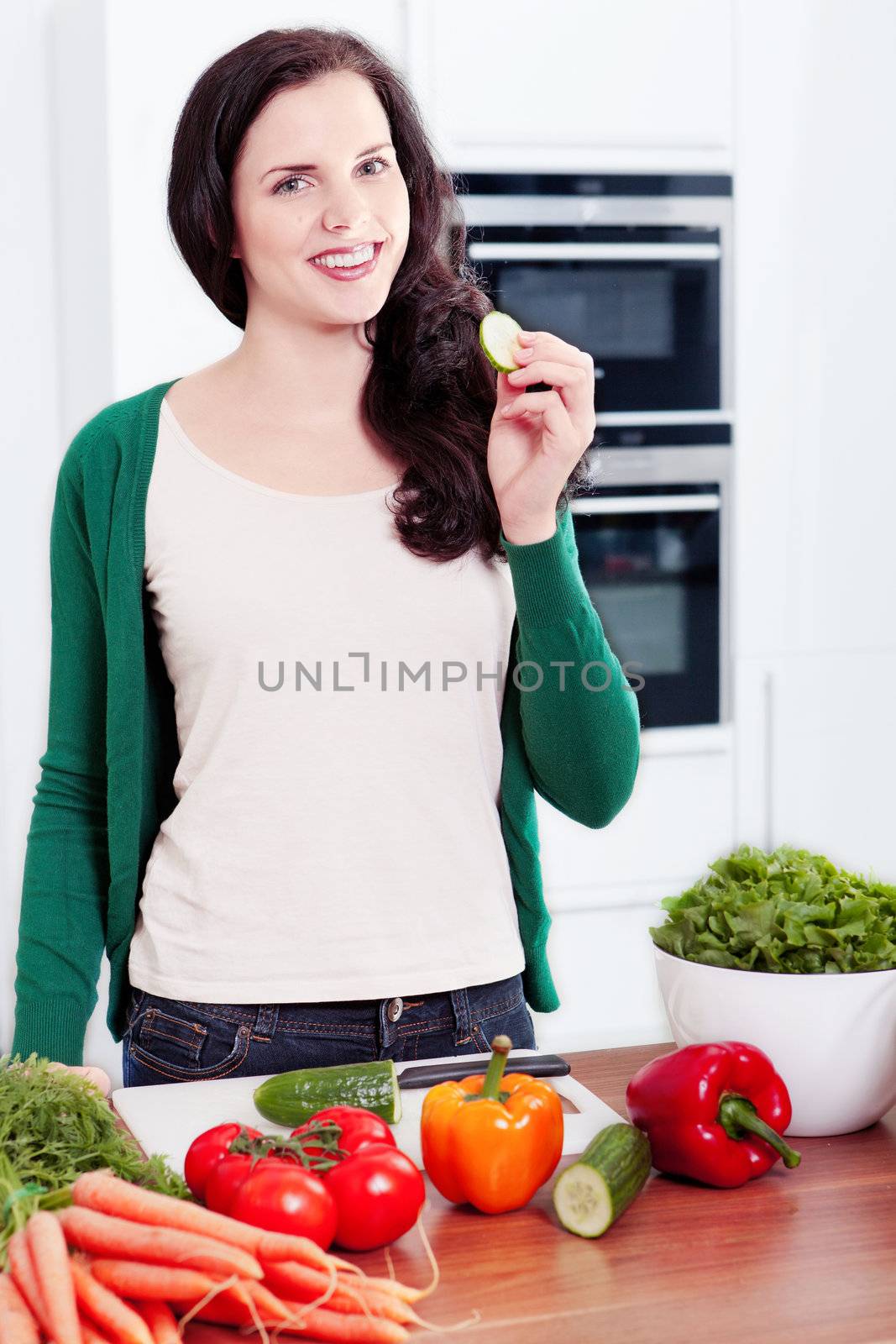 young woman cooking vegetarian food in kitchen