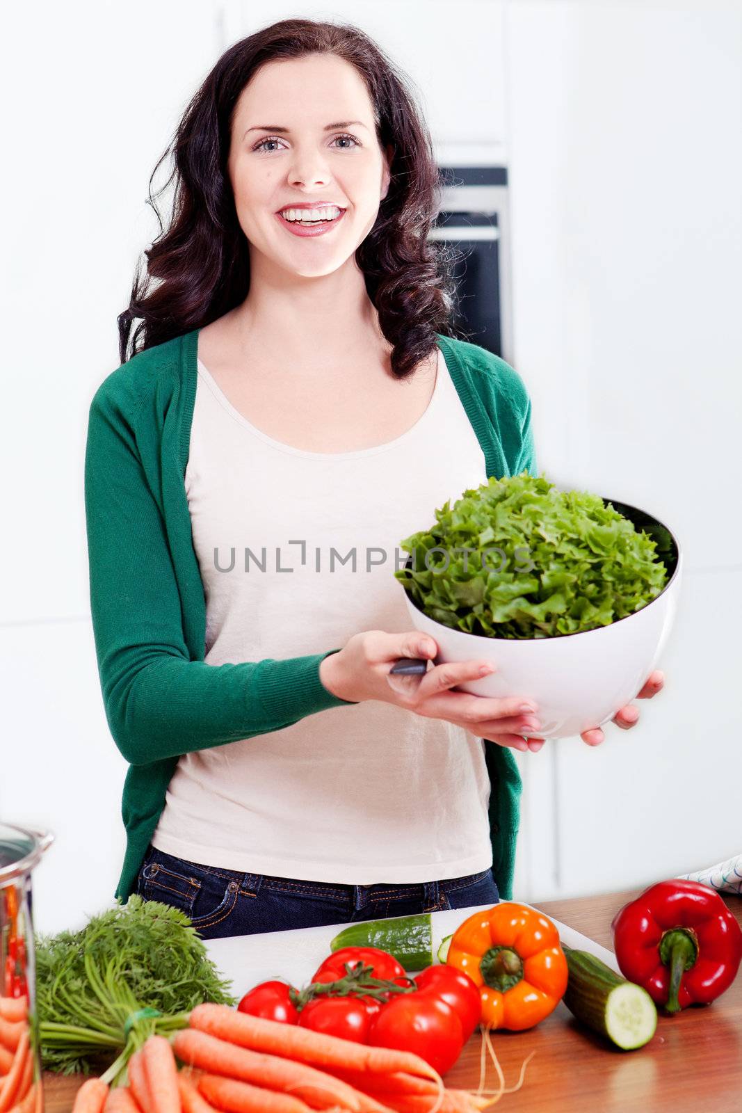 young woman cooking vegetarian food in kitchen