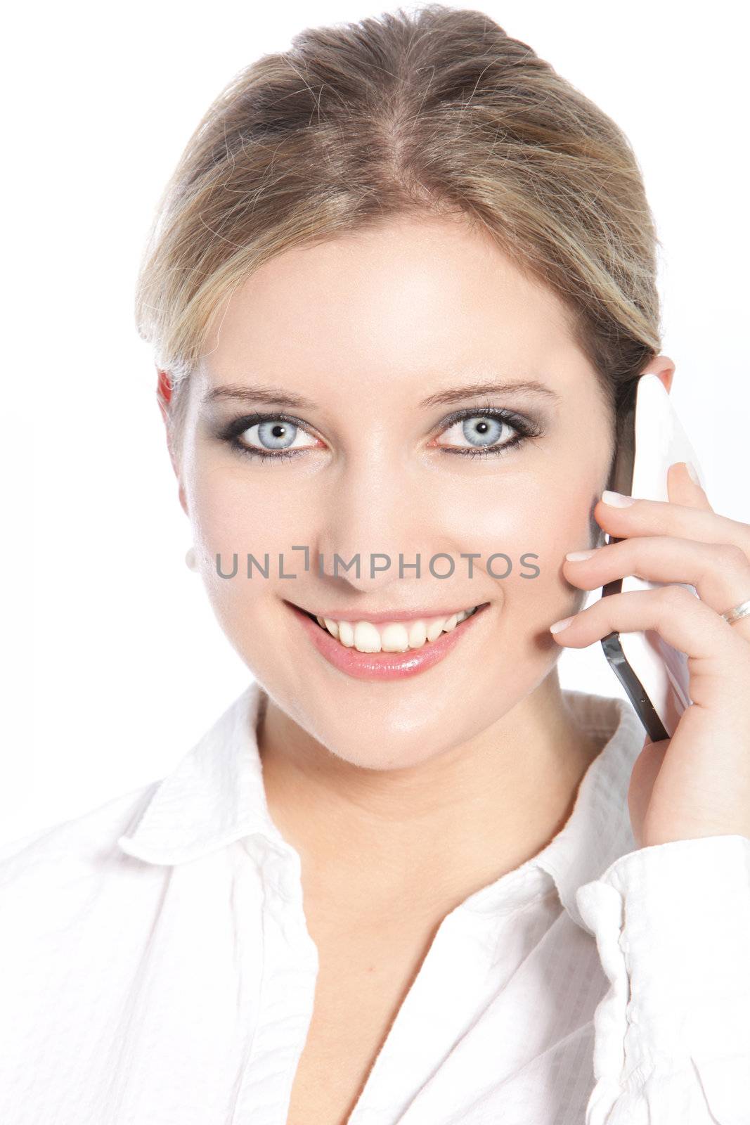 Beautiful happy young woman with a lovely wide smile using a mobile phone isolated on white