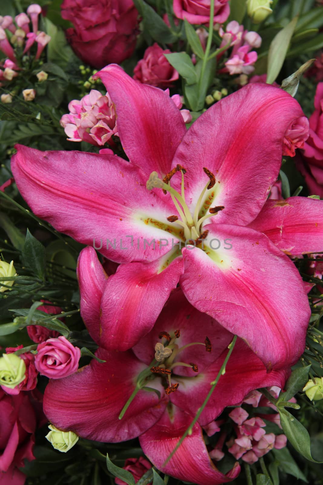 A big pink tiger lily in a floral arrangement