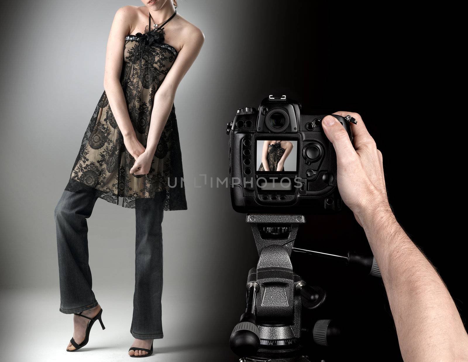 professional photographer at studio fashion shot with a model