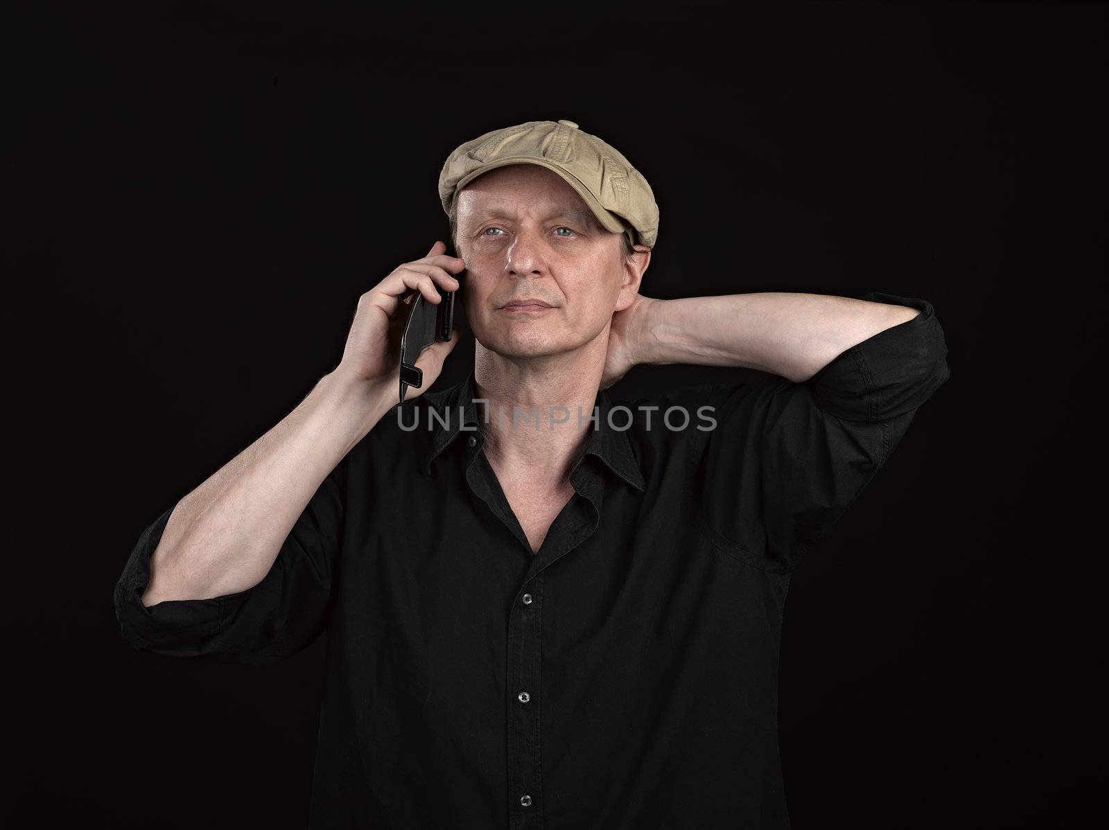 Guy using a mobile phone with copyspace on black