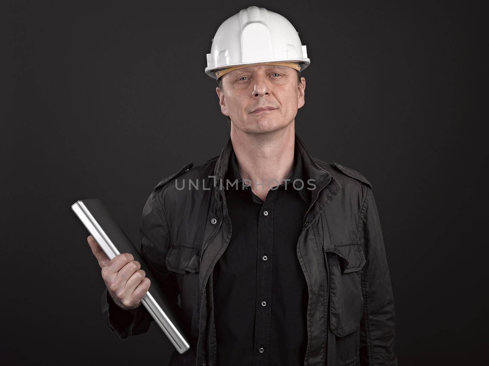 Portrait of a man architect on black background