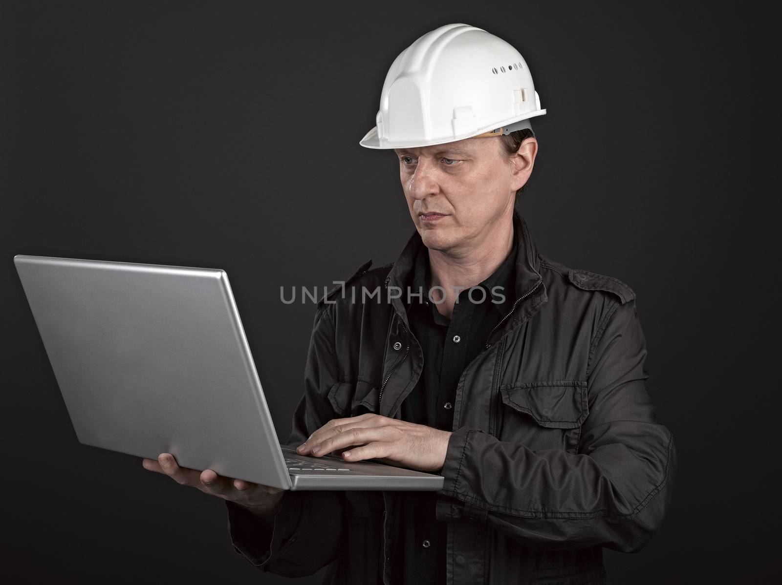 Portrait of a man architect on black background