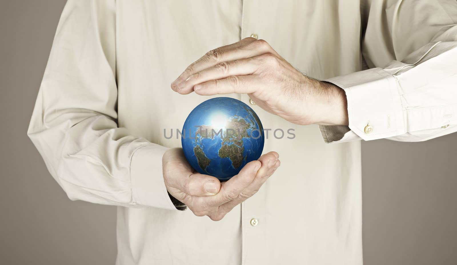 Hands protecting the planet earth