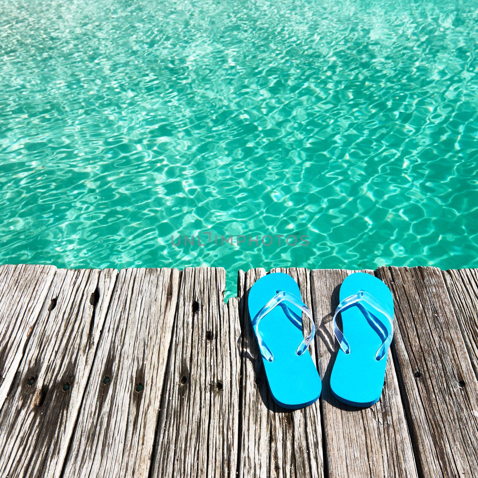 Slippers at jetty by the sea