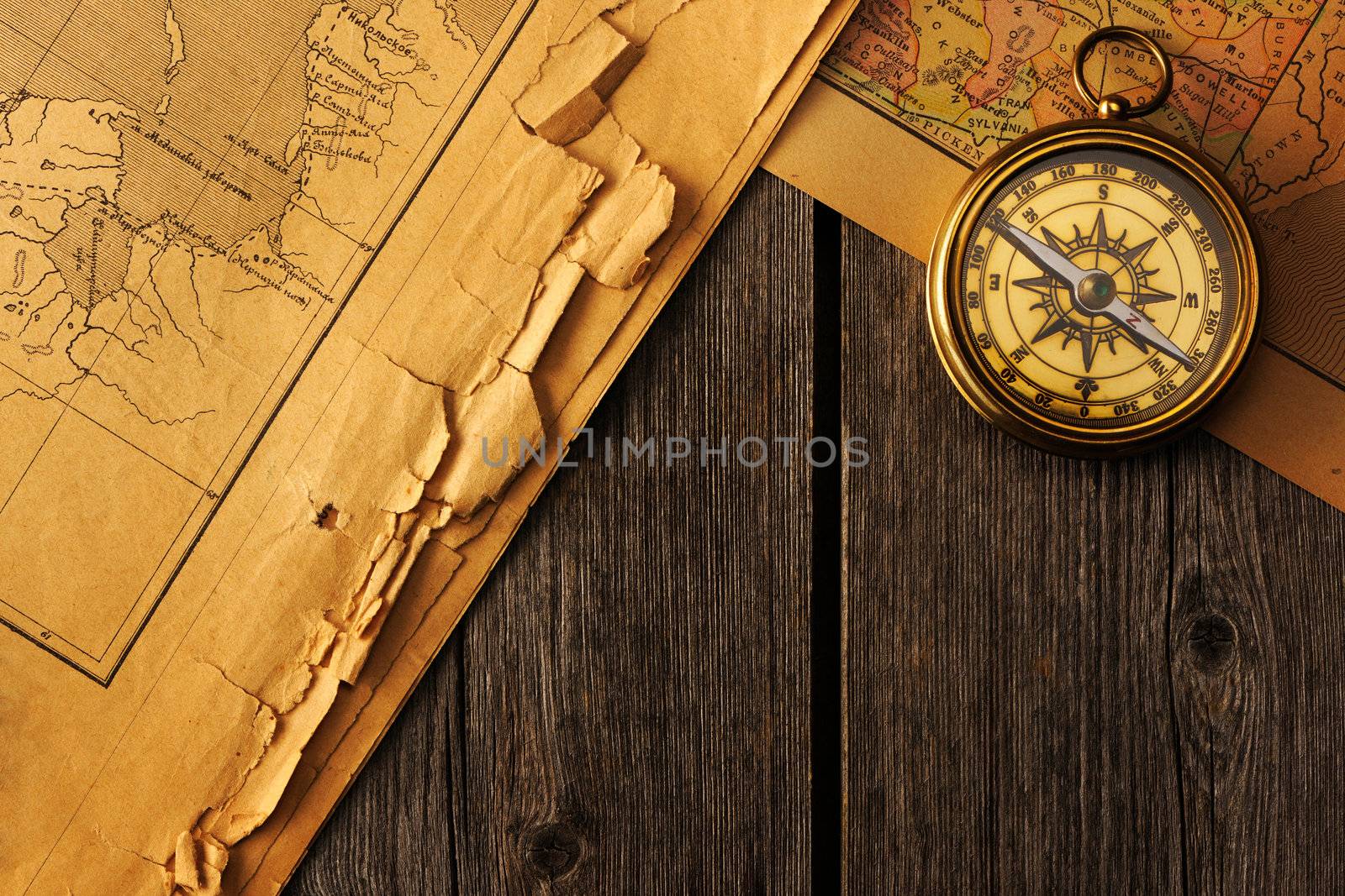 Antique brass compass over old map