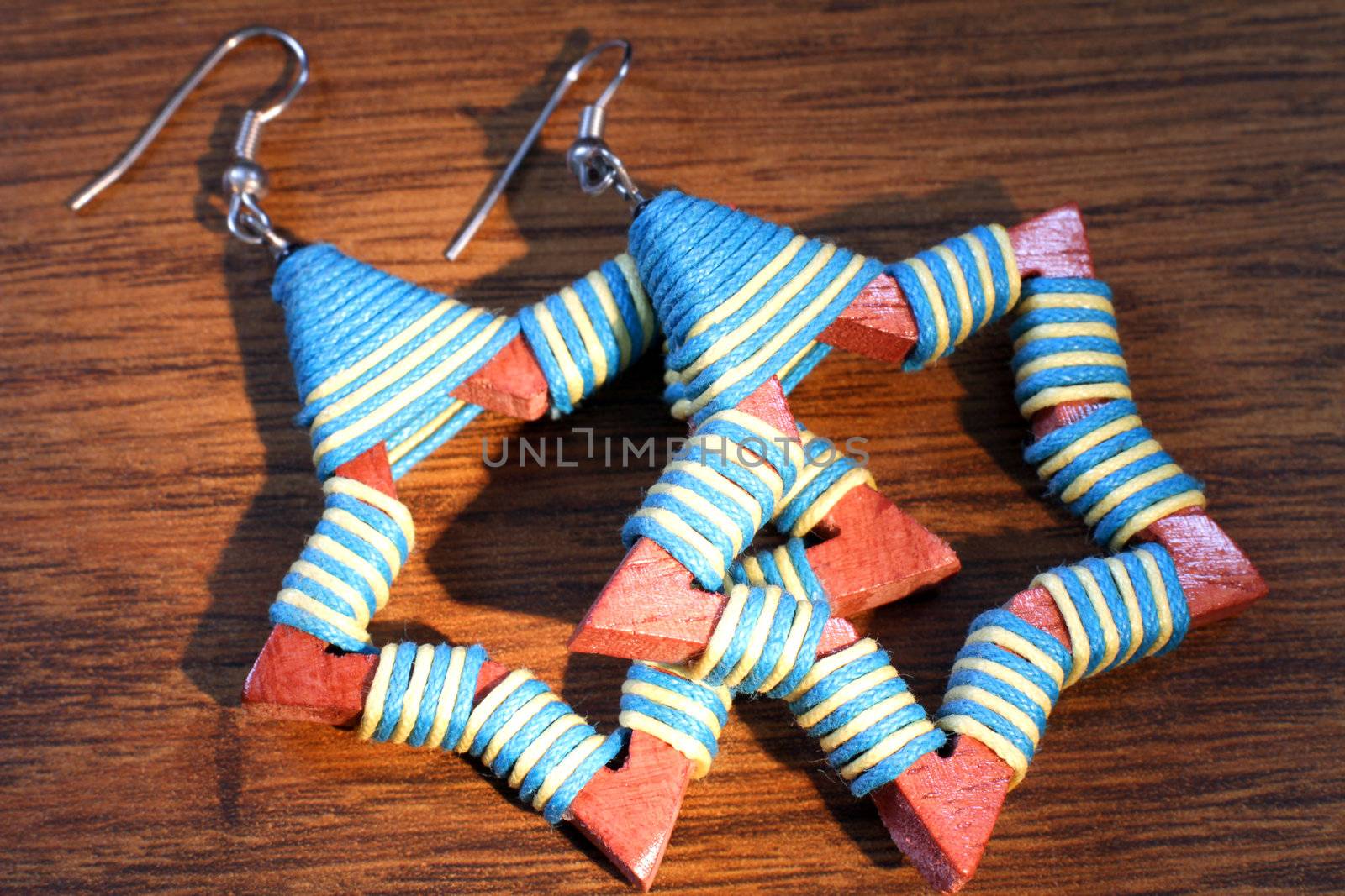 Wooden earrings in ethnic style on the wooden table