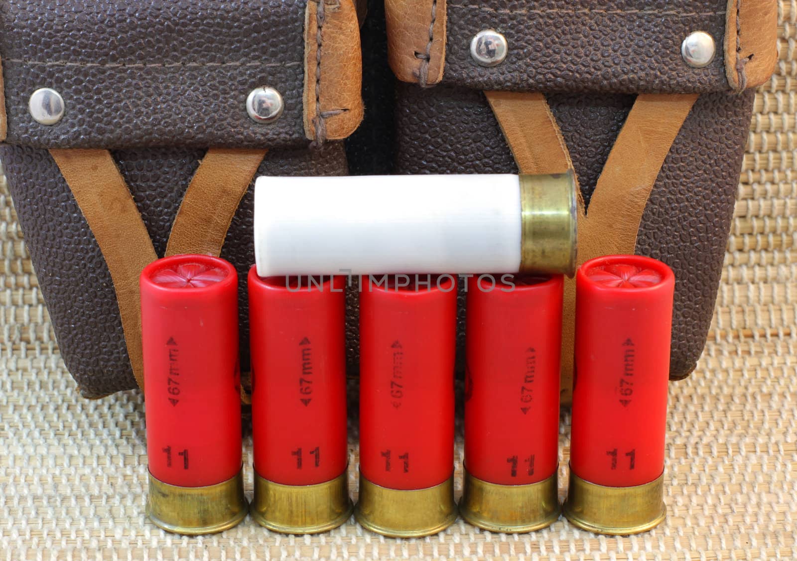 five red and white shotgun cartridges 11 and 12 and hunting bag