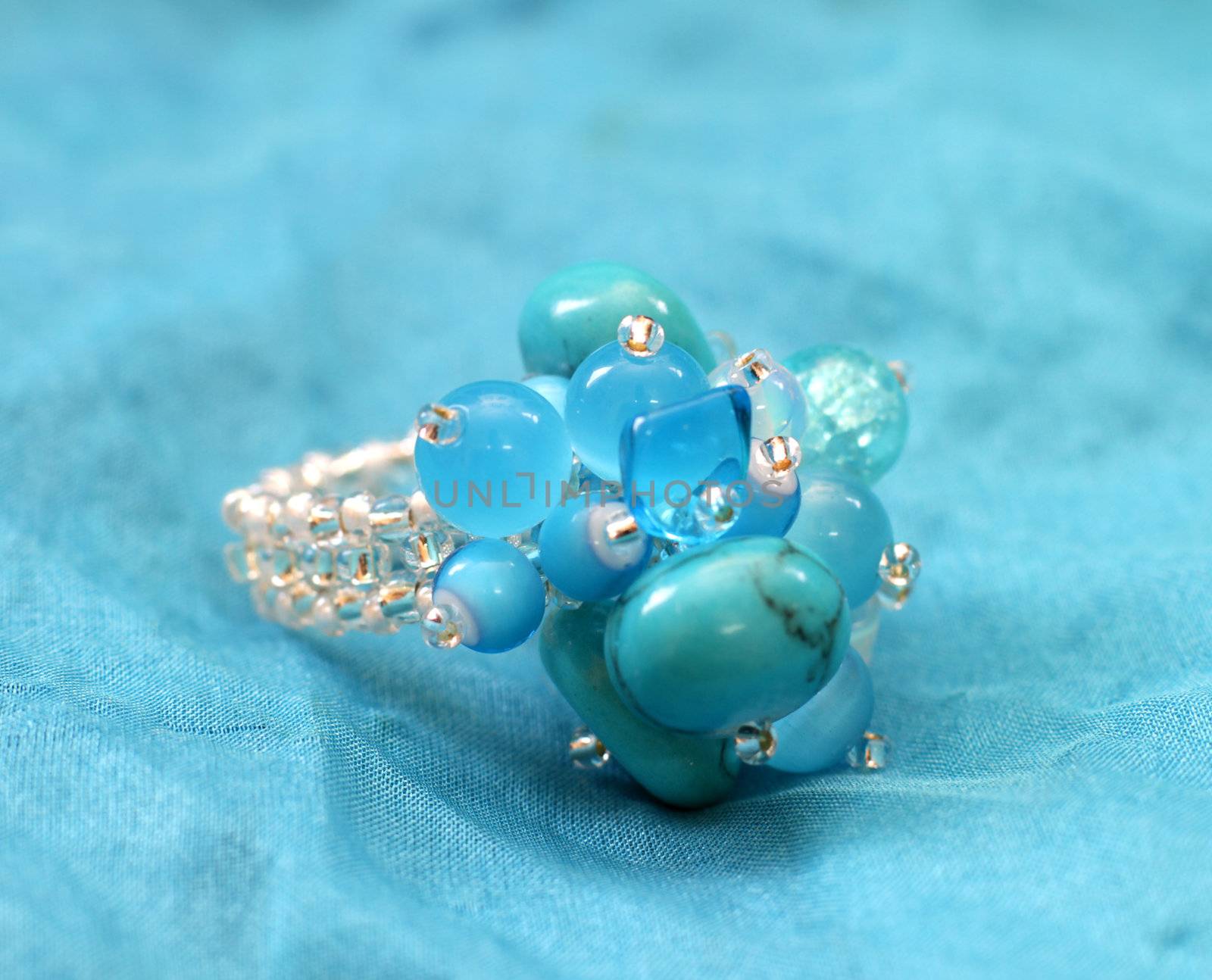 original handmade (glass) beads ring on blue