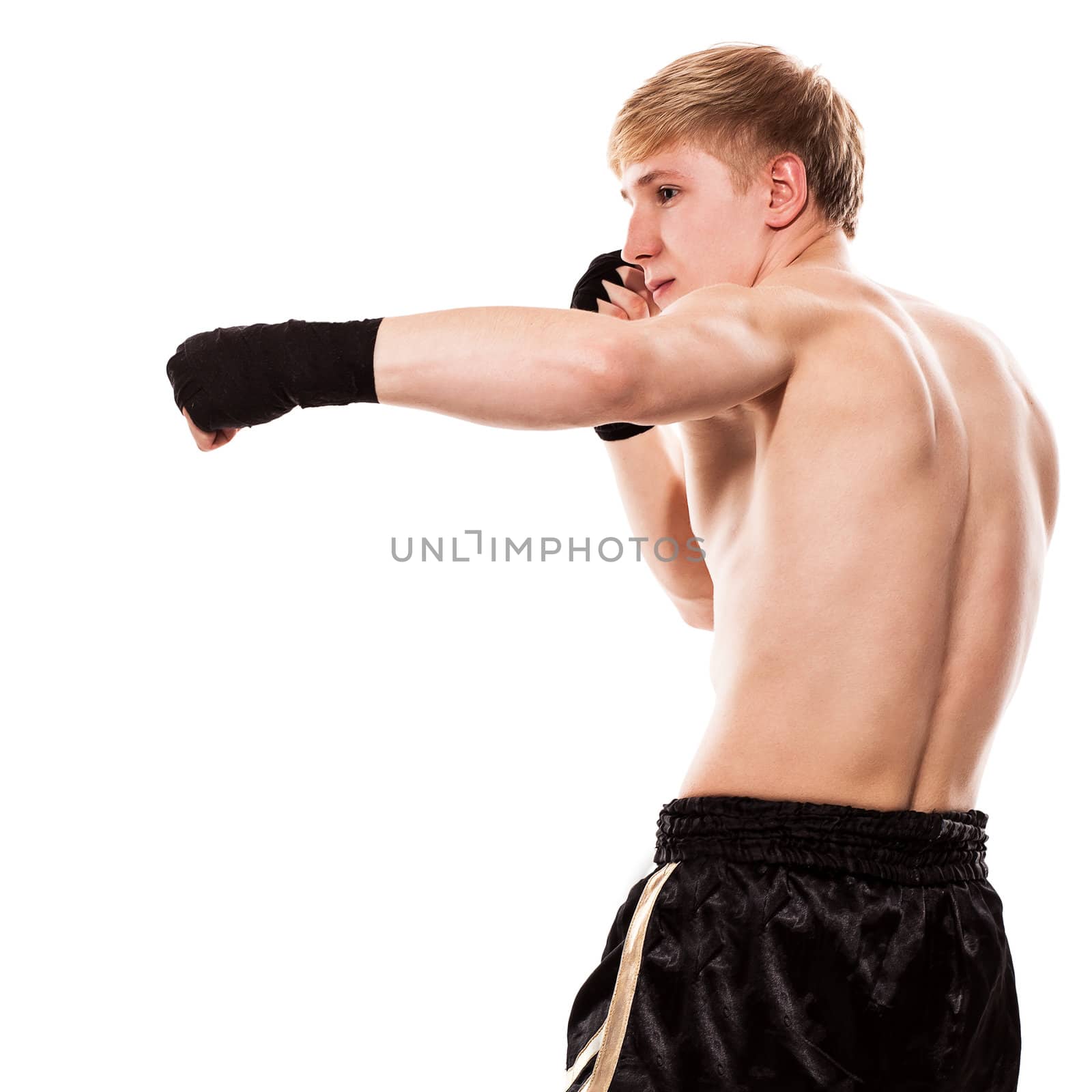 Young handsome fighter in shorts isolated over white baqckground