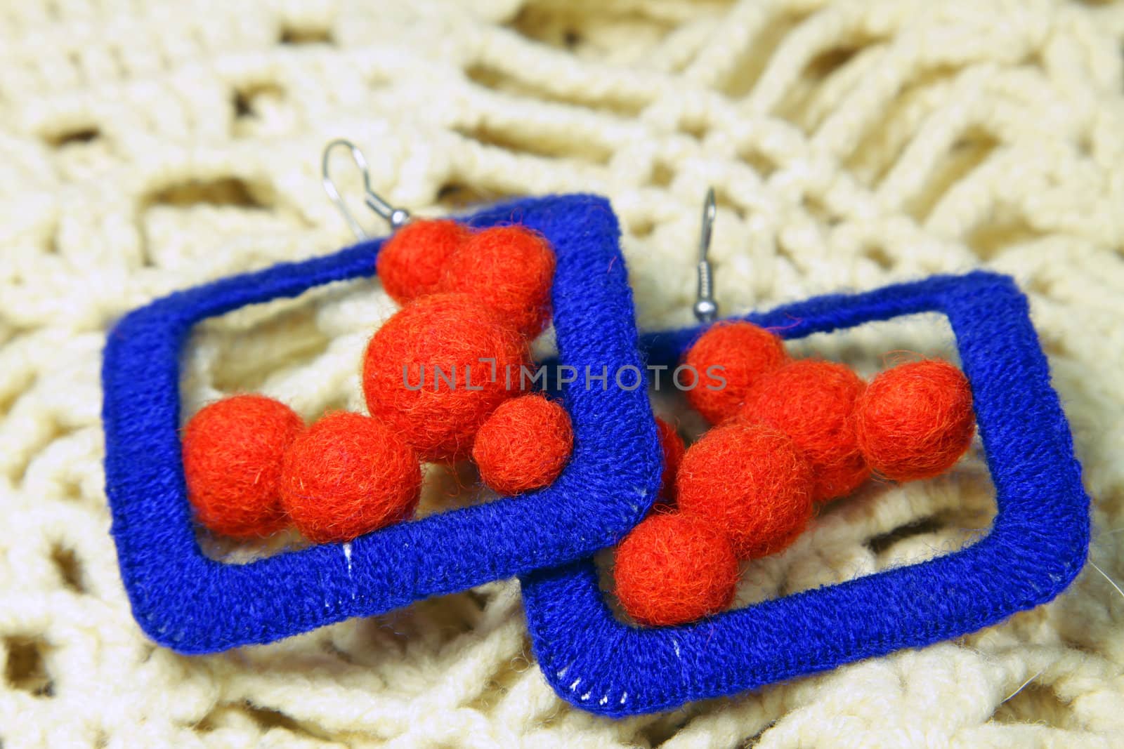 Knitted earrings on the knitted scarf. Handmade.
