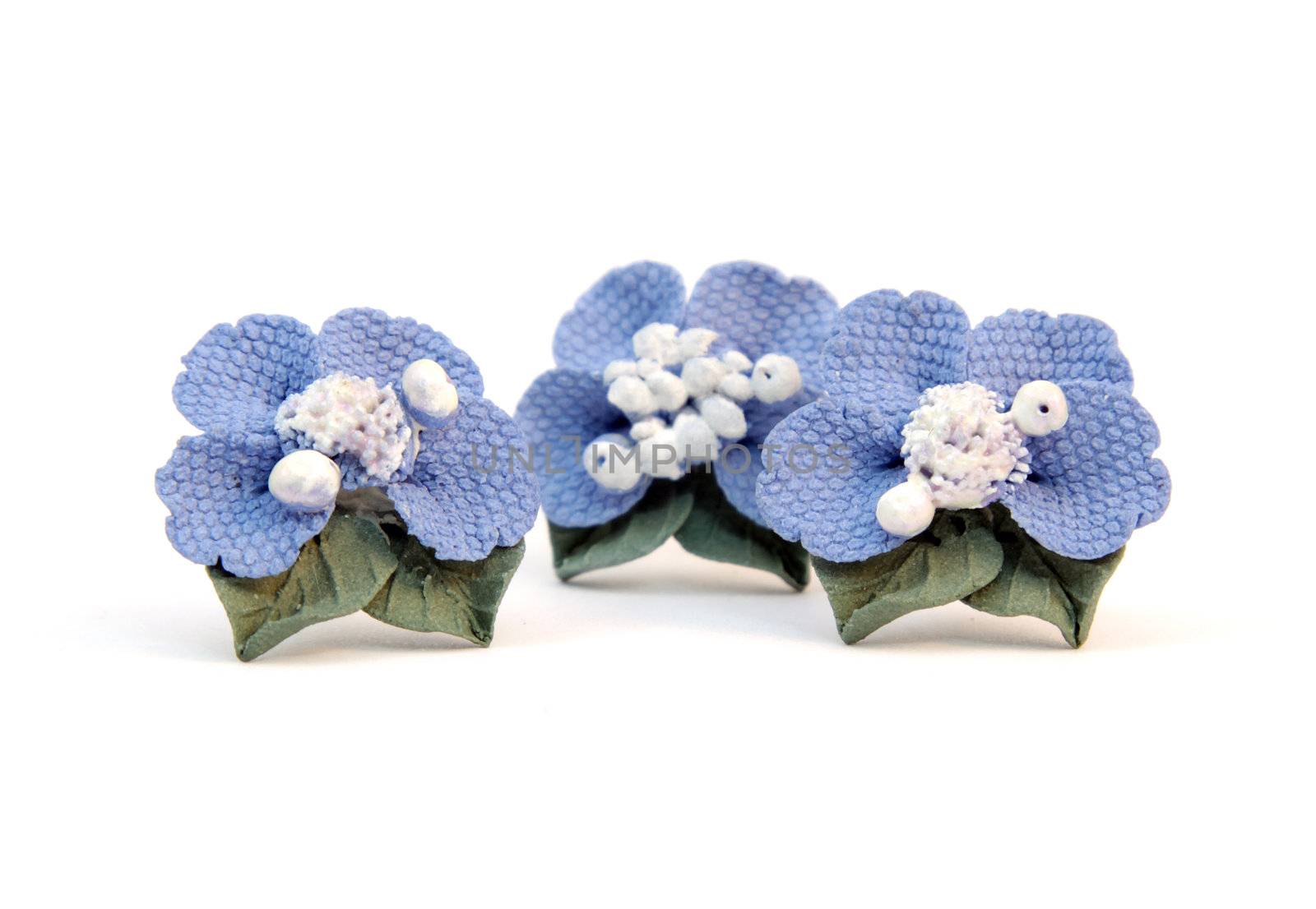 Earrings blue flower of the plastic clay isolated on a white background