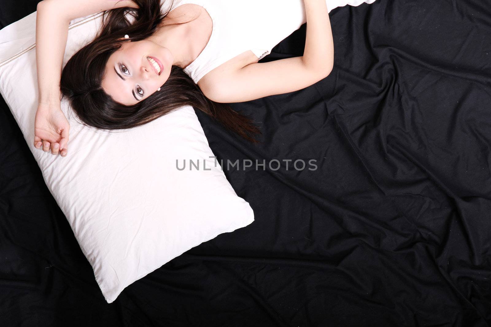 A young hispanic Woman sleeping on the Bed.