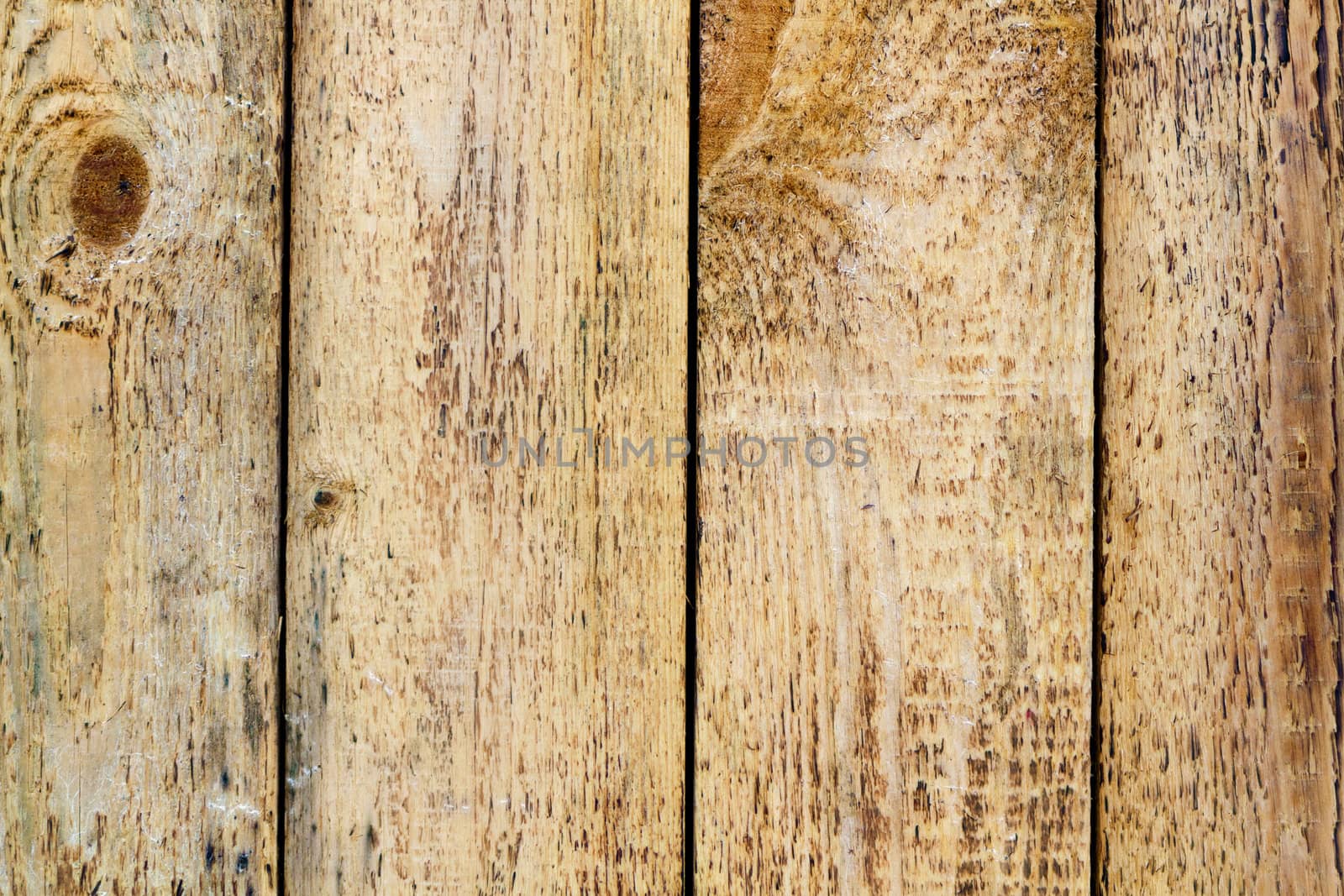 unplaned wall of rough wooden planks close-up