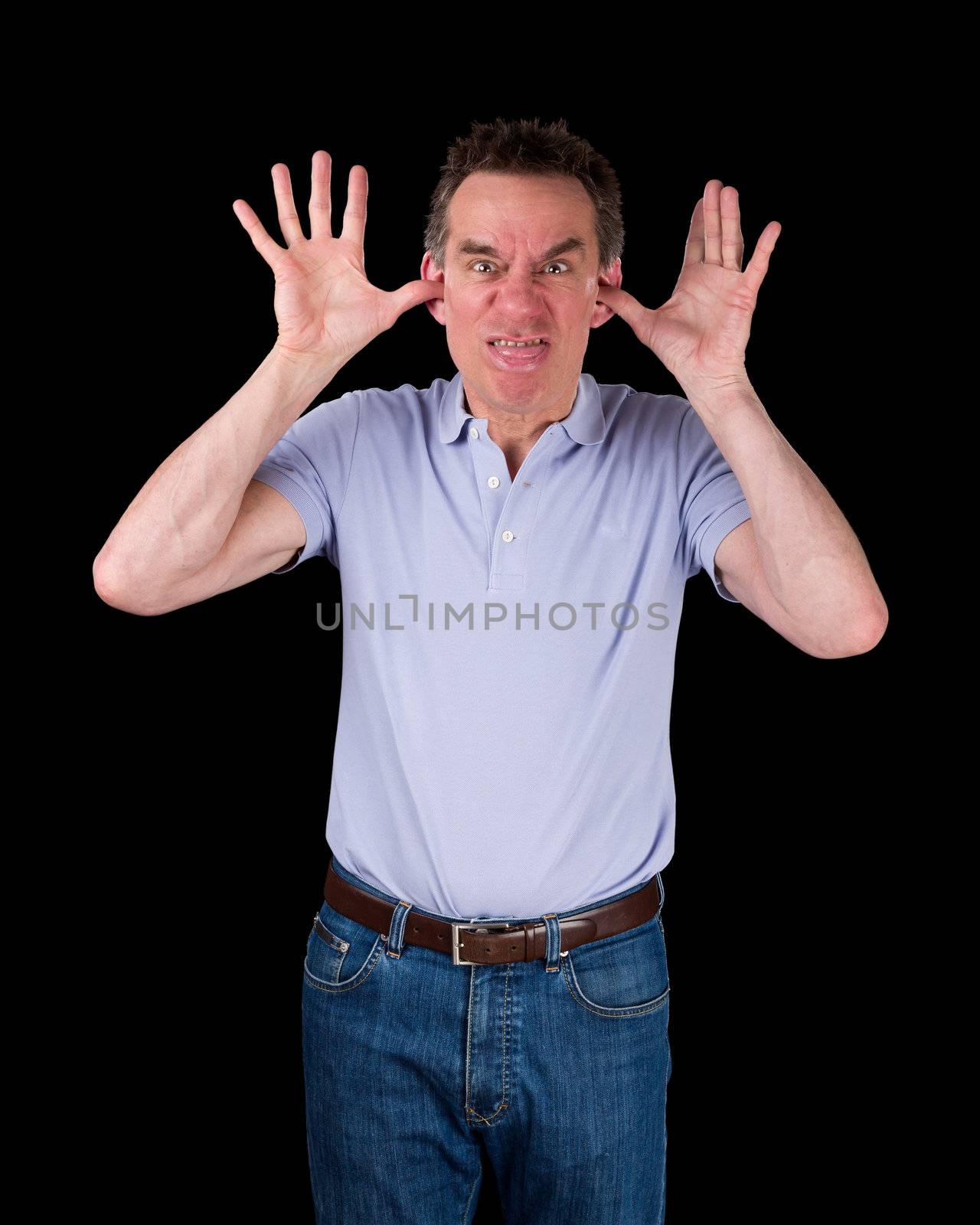 Angry Middle Age Man Poking Out Tongue with Hands in Ears Black Background