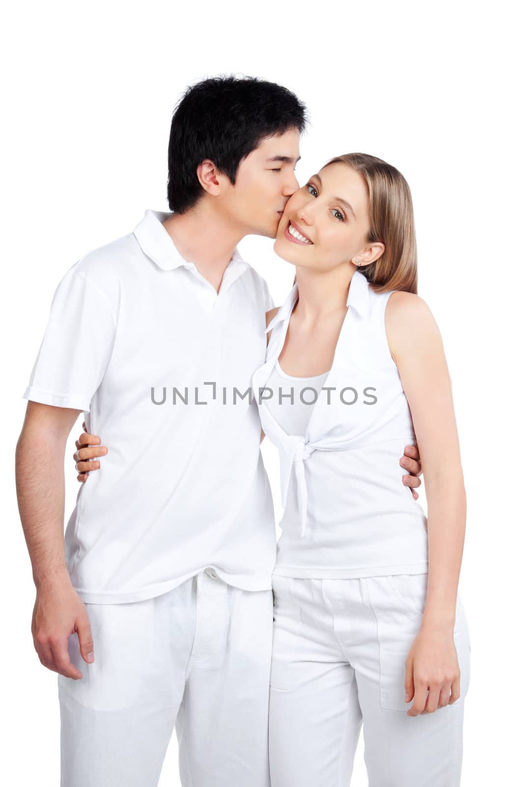 Portrait of young man kissing the young woman isolated on white background.