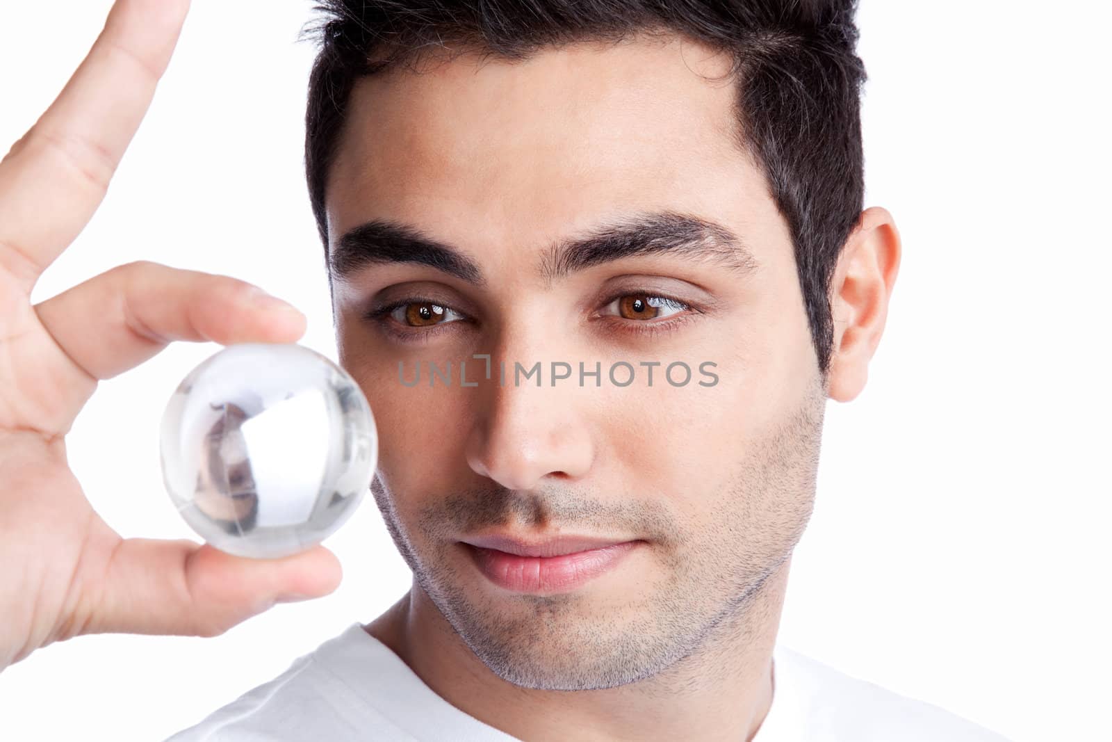Portrait of young man holding crystal ball isolated on white background.