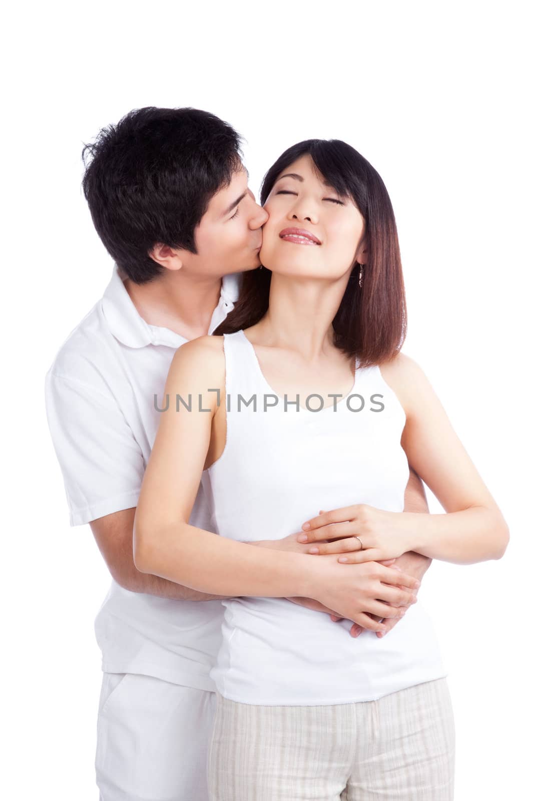 Portrait of man kissing woman on cheek isolated on white background.