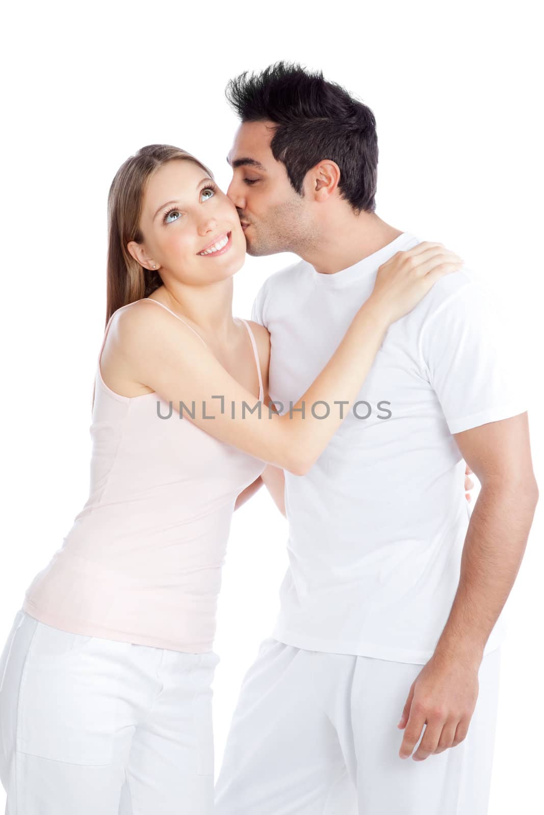Portrait of young man kissing the young woman isolated on white background.