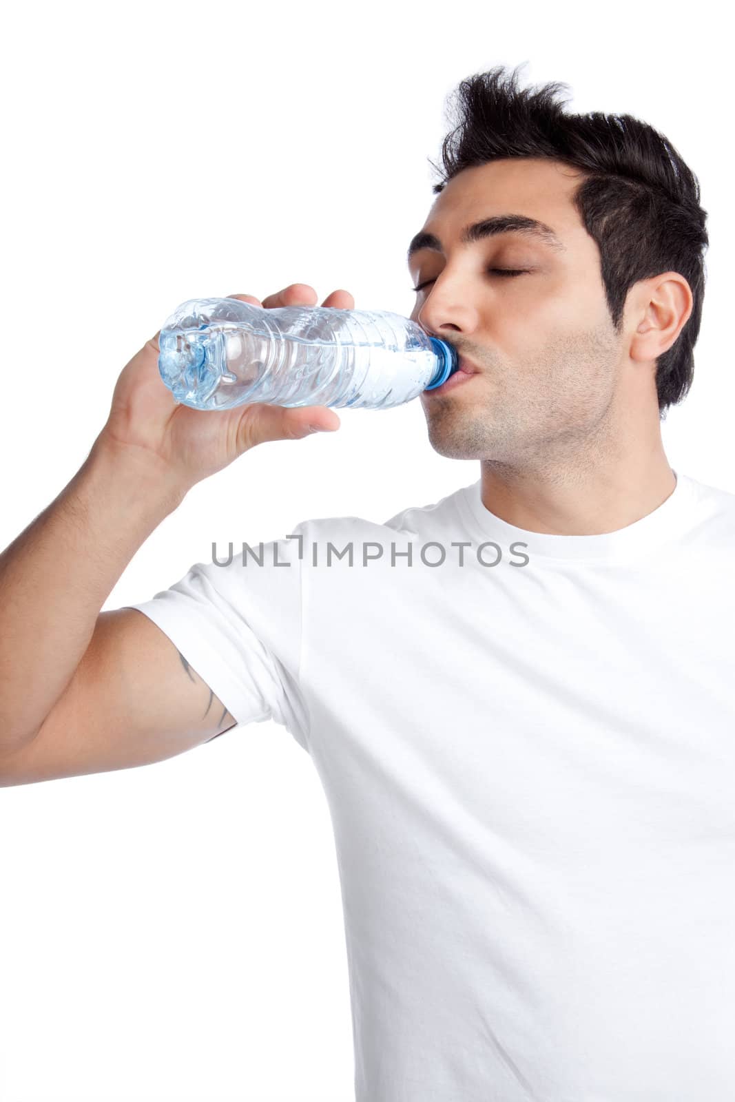 Portrait of young man drinking water from bottle isolated on white background.
