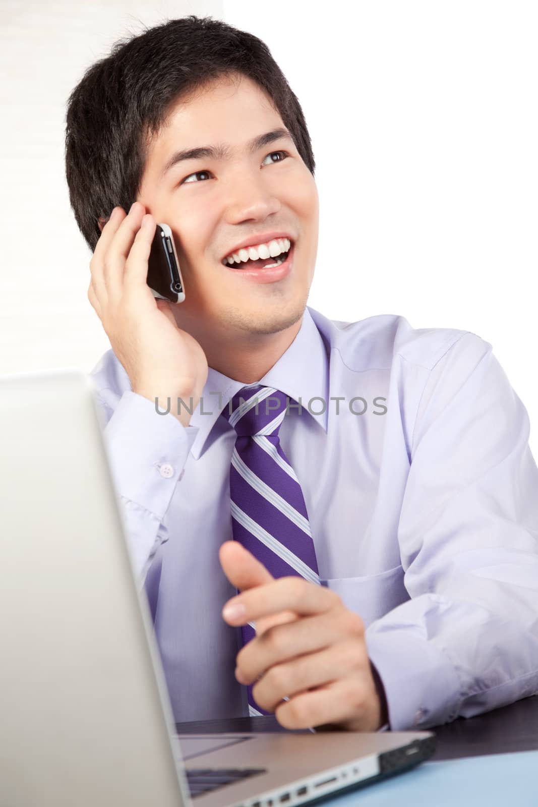 Asian businessman talking on cell phone at work isolated on white background.